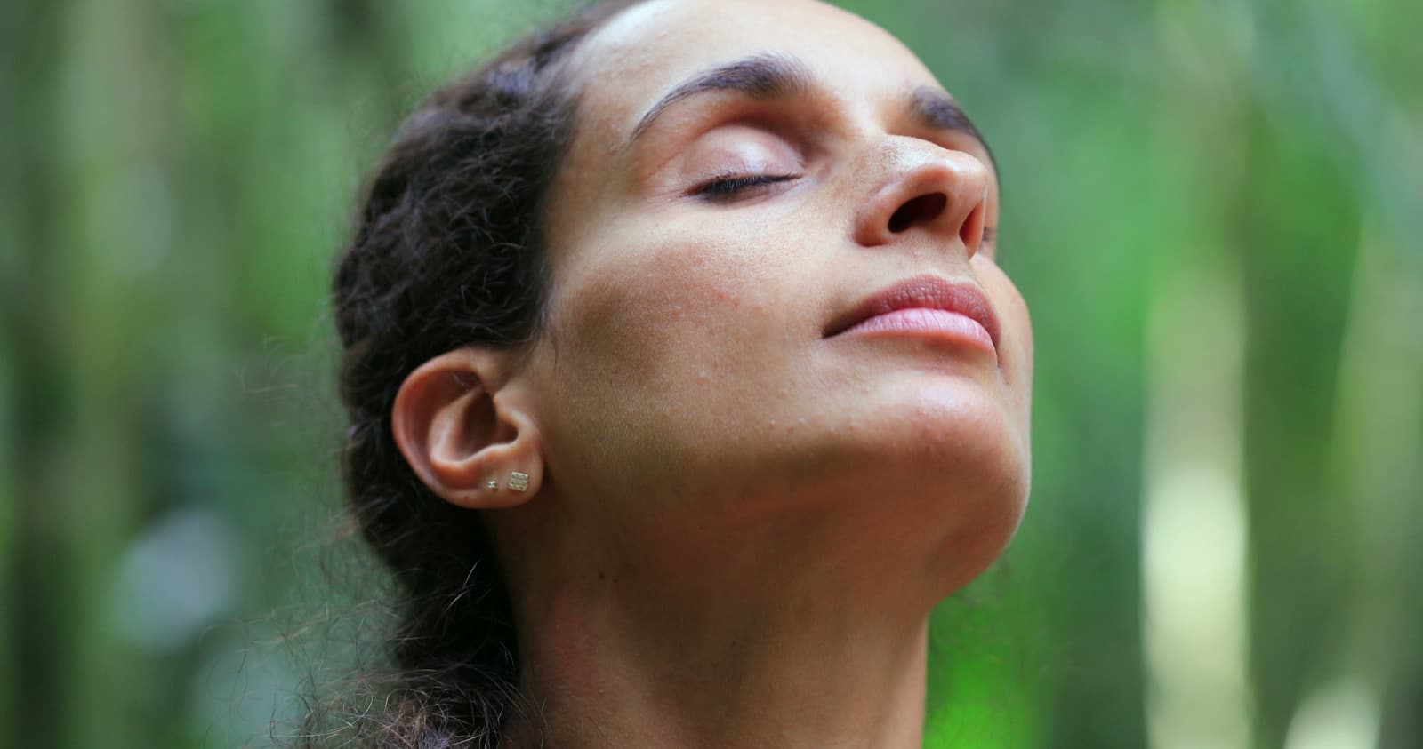 A woman breathing deeply with eyes closed