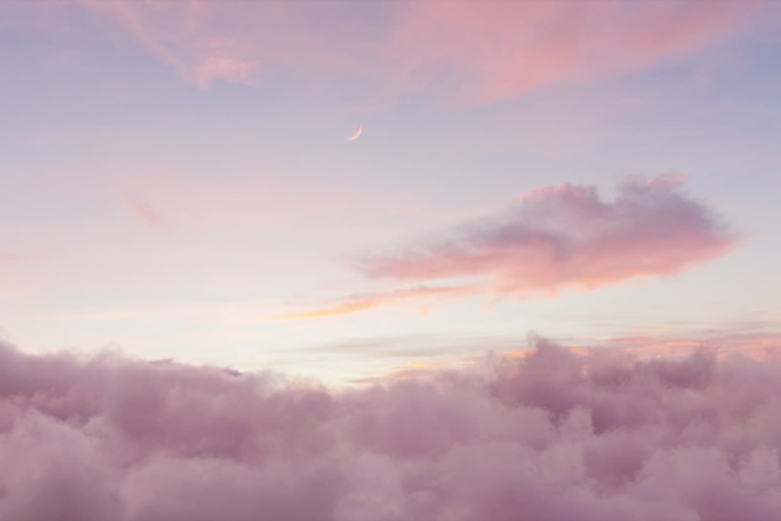 Lilac clouds under a crescent moon